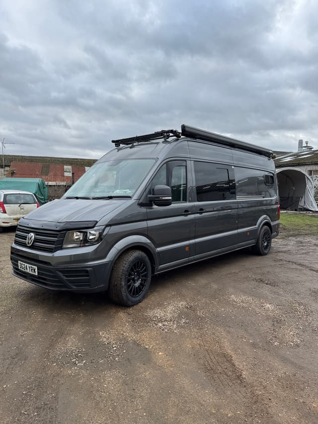 Grey Volkswagen camper van with roof awning