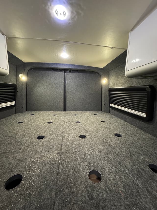 Camper van rear workspace with fitted storage